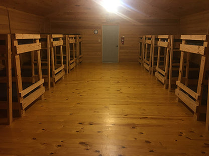 Photo of inside the cabins. Bathrooms and showers are off to the right. No one will have to sleep on a top bunk.